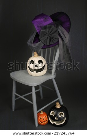 View of Halloween Pumpkins on a chair against a dark background
