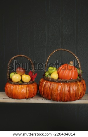Apples and pumpkins in basket on textured background, fall or thanksgiving theme