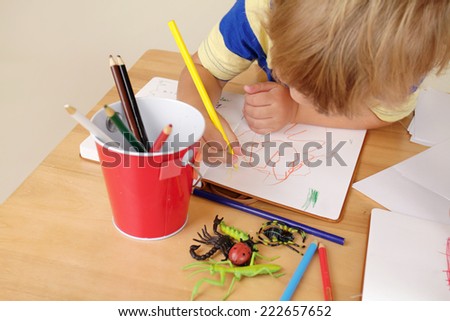 Kids, children engaged in art and craft with pencils and paper, learning and education concept