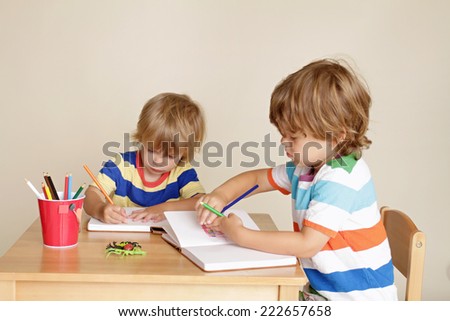 Kids, children engaged in art and craft with pencils and paper, learning and education concept