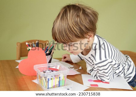 Child, kid engaged in arts and crafts activity, creative learning and education concept