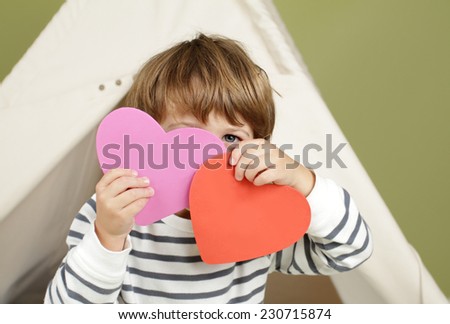 Child, kid, engaged in a Valentine\'s Day arts and crafts activity