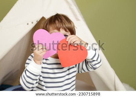 Child, kid, engaged in a Valentine\'s Day arts and crafts activity