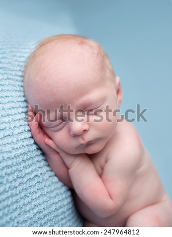 Newborn infant baby asleep posed on a blanket, nap time