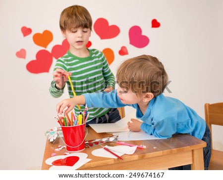 Kids, children, doing Valentine's day arts and crafts with hearts, pencils, paper