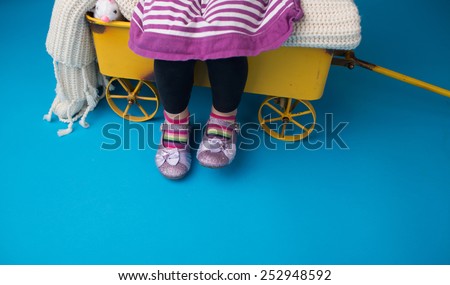 Child, girl fashion: striped socks and dress and girly sparkly shoes