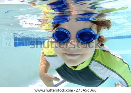 Child, kid, diving and swimming in pool underwater, summer or sports theme