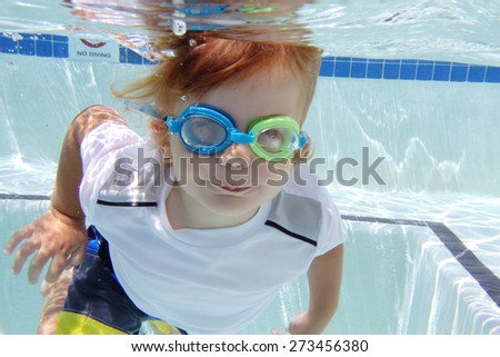 Child, kid, diving or swimming in pool underwater, summer or sports theme