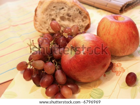 View of apples, grapes and bread on a table
