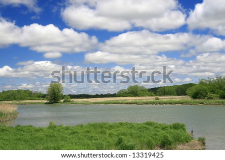 Scenic river landscape with a curving river and dramatic cloudscape at Montezuma Park in upstate New York in the Finger Lakes area