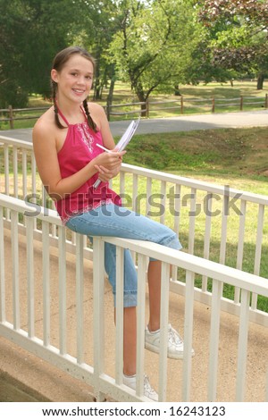 School girl with a notebook, planner in an outdoors setting