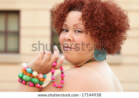 stock photo : Portrait of a female with short curly red hair and bright 