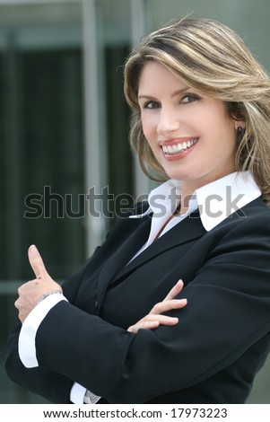Portrait of an attractive business, corporate female in a suit giving a \