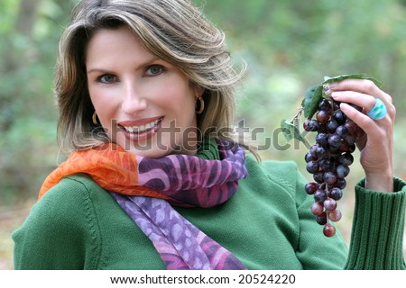 Eating Grapes - gorgeous caucasian woman eating grapes outdoors in a park, seasonal, fall theme