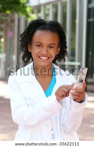 Smiling African American Teenager Girl on Cell Phone, texting or dialing