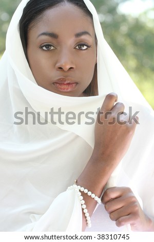 Muslim, Islamic woman: covering head with shawl or veil, head scarf