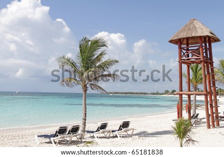 Empty white sand beach, ocean and palm trees in Mexico, Riviera Maya