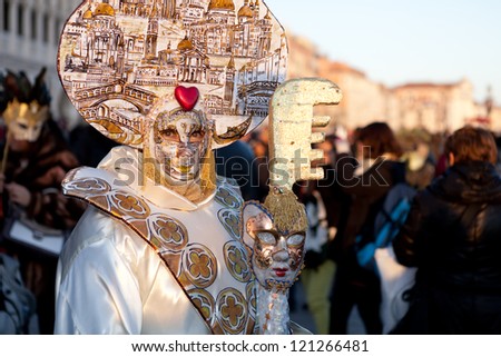VENICE, ITALY - FEBRUARY 17: Unidentified person in Venice mask at St. Mark\'s Square, Carnival of Venice on February 17, 2012. Annual carnival was held in 2012 from February 11 to February 21, 2012.
