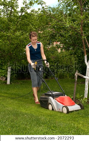 Young woman with electric lawn-mower