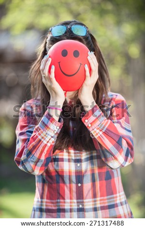 Closeup of a young girl with a balloon face vertical