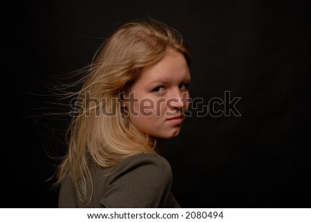 Portrait of a blond girl close-up turned away