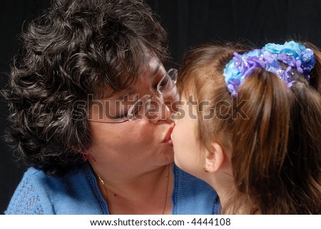 Mother and daughter kissing