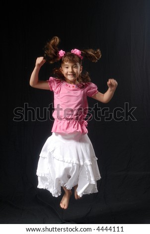 Little Asian girl jumping smiling