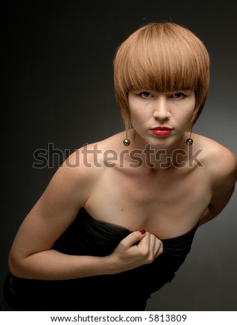 Red haired girl posing leaning forward looking straight