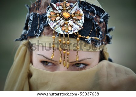 Close-up of a tribal woman hiding her face looking sideways