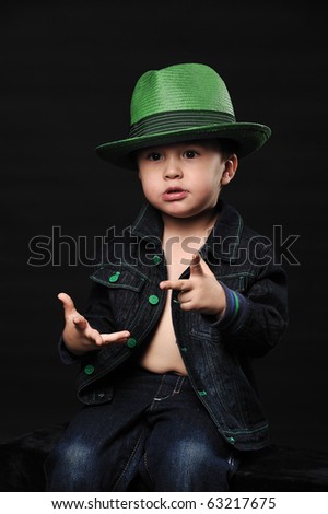 Cool little boy in a fancy hat counting using his fingers