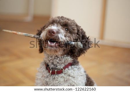 dog biting paint brush