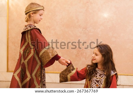 boy giving girl hand during theater play