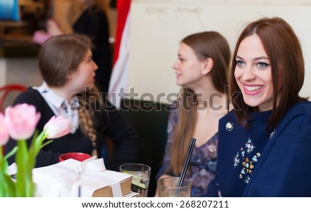 girls having small talk in cafe