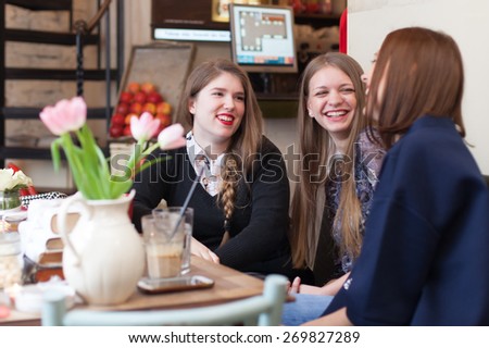 girls having small talk in coffee shop