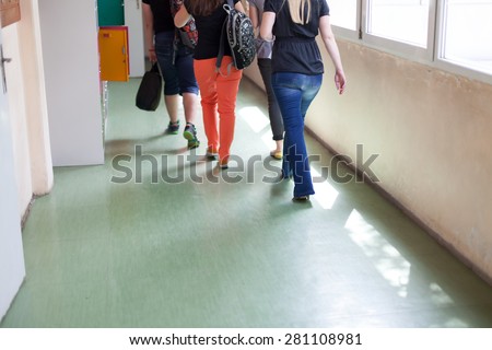 students walking through school corridor