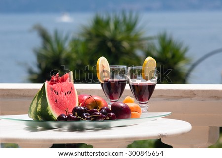 fruit and wine on table with sea view