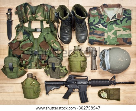 set of military equipment on a wooden background