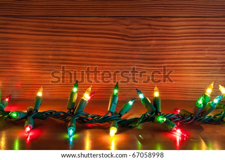 christmas lights on a wooden shelf with natural wood background