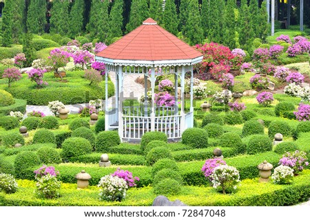 pavilion around with topiary work and flower decoration green garden