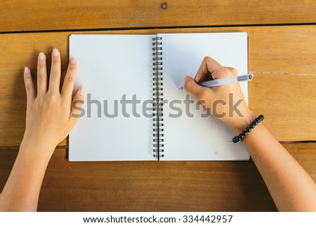 girl drawing a doodle on notepad/notebook