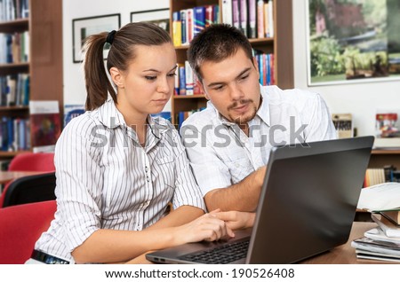 Students researching online at the library on computer