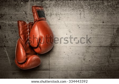 Boxing gloves hanging on concrete wall