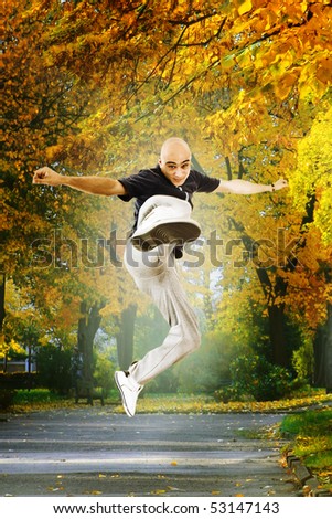 Young man jumping in the park - Karate kick