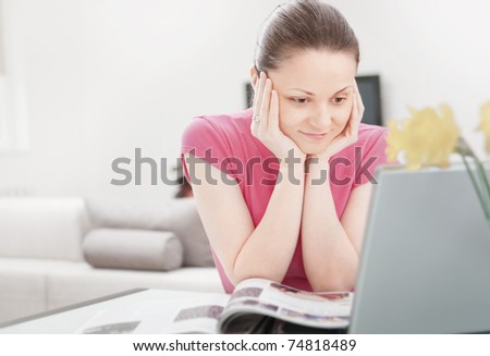 Young woman looking at laptop with smile