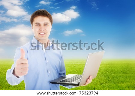 Freedom -Young happy man with laptop in nature