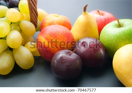 Fruits. Various fresh ripe fruits close-up: plums, peaches, pears, apples and grapes.