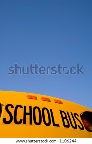School bus under a blue sky with copy space.