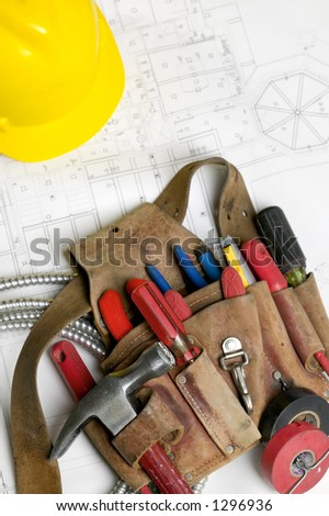 Electricians tool belt hard hat and electrical plans Electricians tool belt hard hat and electrical plans