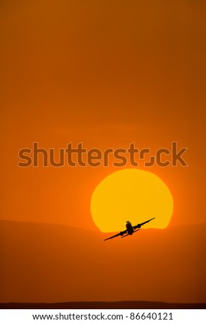 Airplane Taking Off At Sunset