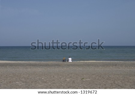 man and woman watching at the sea